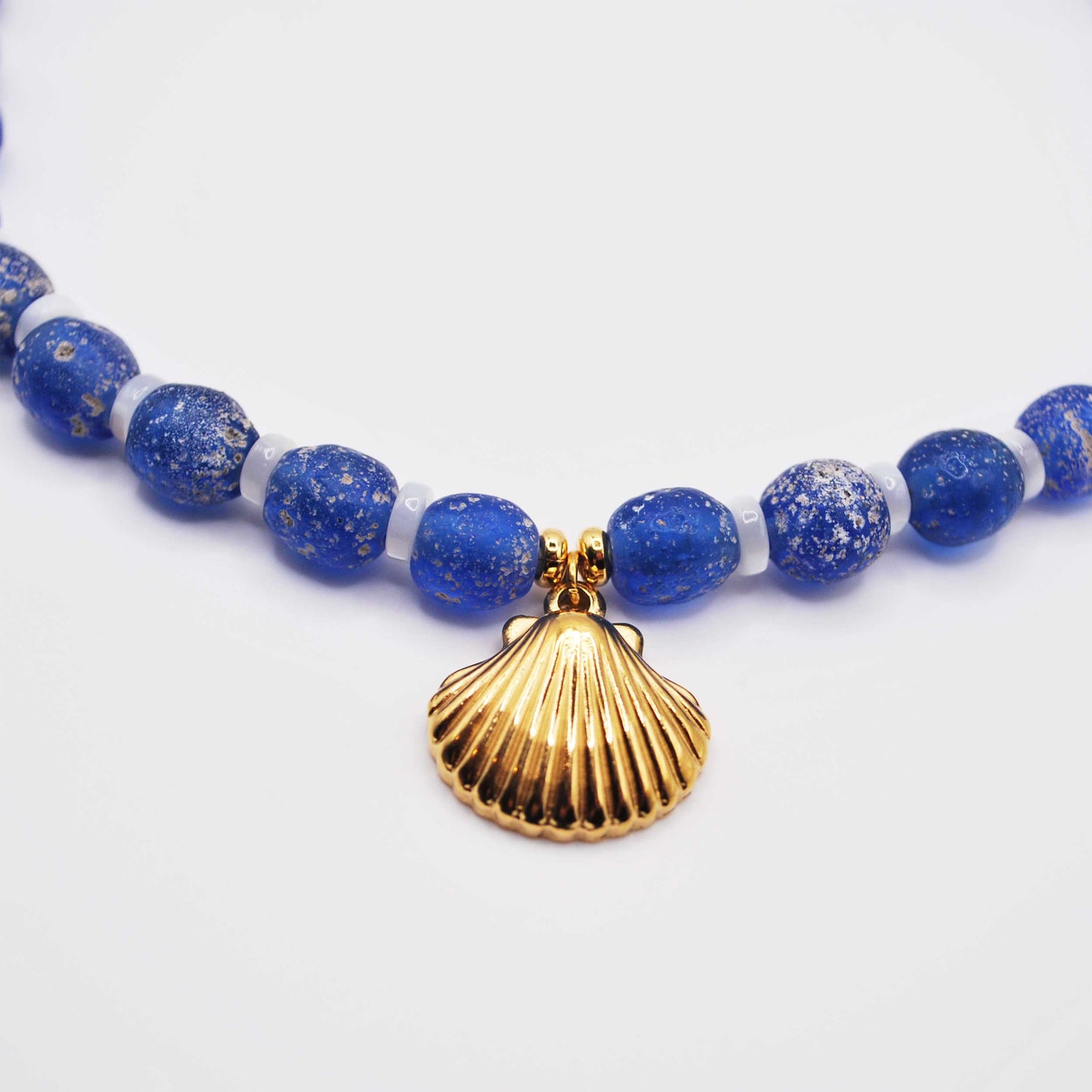 'blue current' blue beaded choker with gold callico shell charm