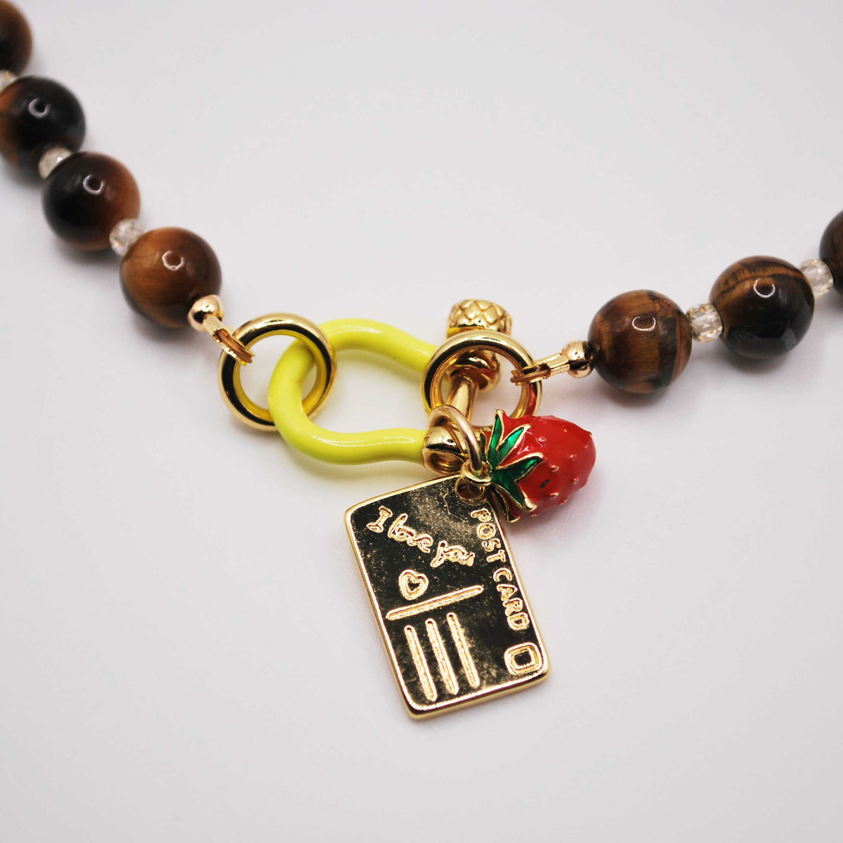 'sweet somewhere' tiger's eye beaded necklace with strawberry and postcard charms