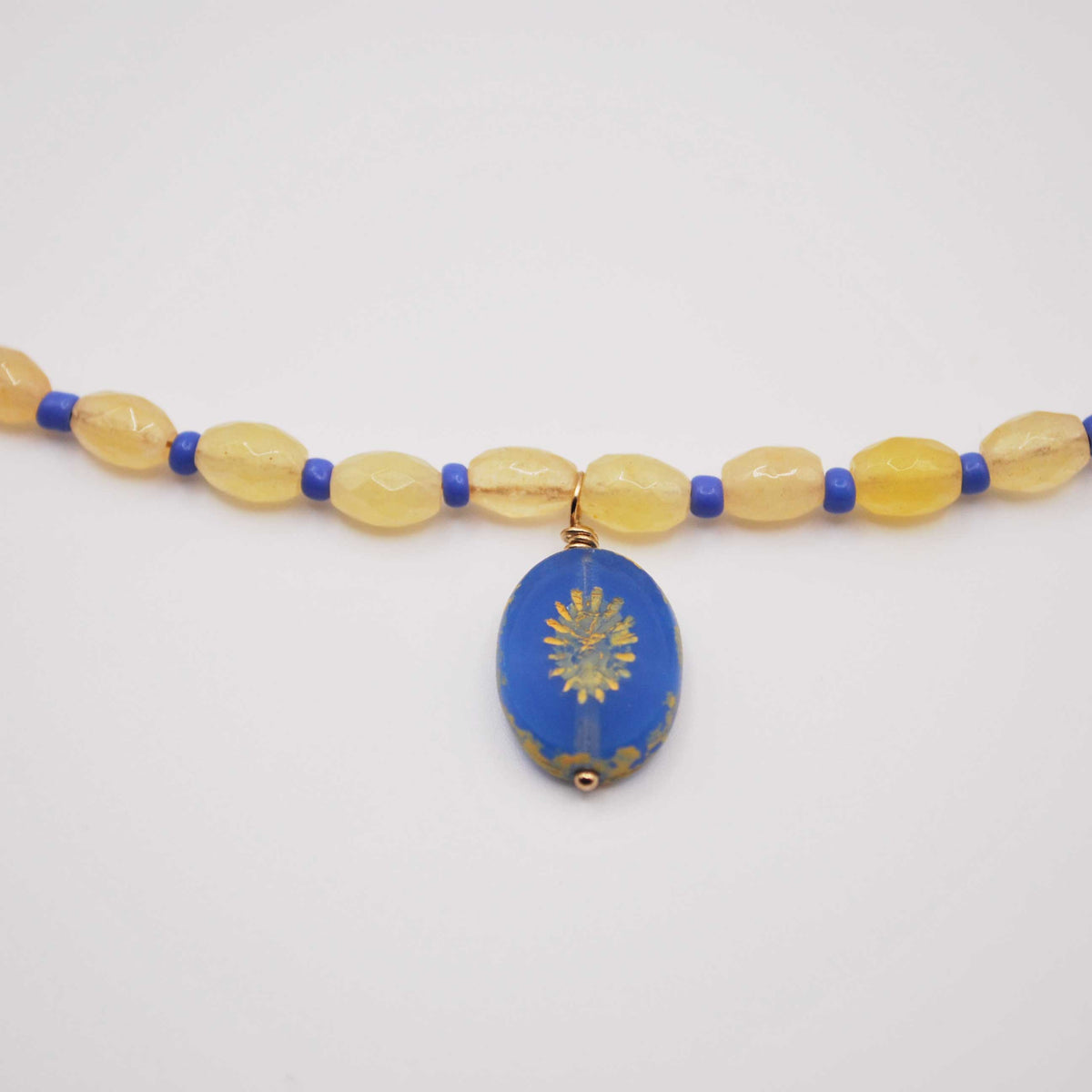 'citrine tide' beaded necklace with blue sunburst charm