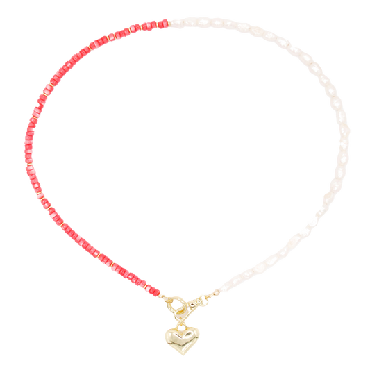 The 'tide and love' necklace pairs handcrafted pearl and coral beads with a meaningful heart charm