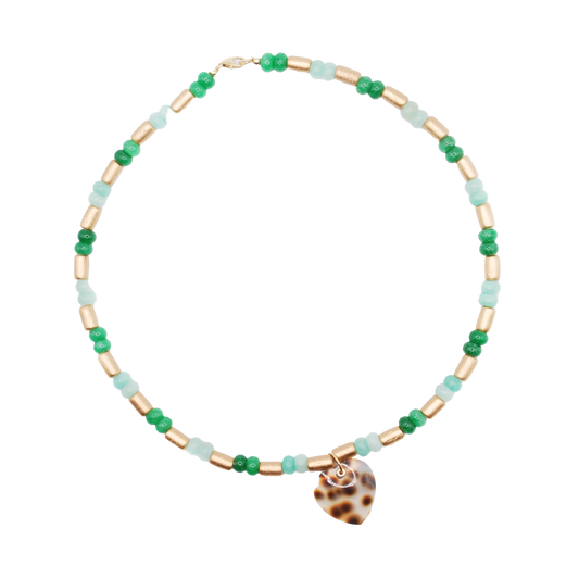 Bold yet wearable, the 'tide breaker' necklace features handcrafted green beads, paired with wooden bead accents and finished with a tiger cowrie shell heart pendant.