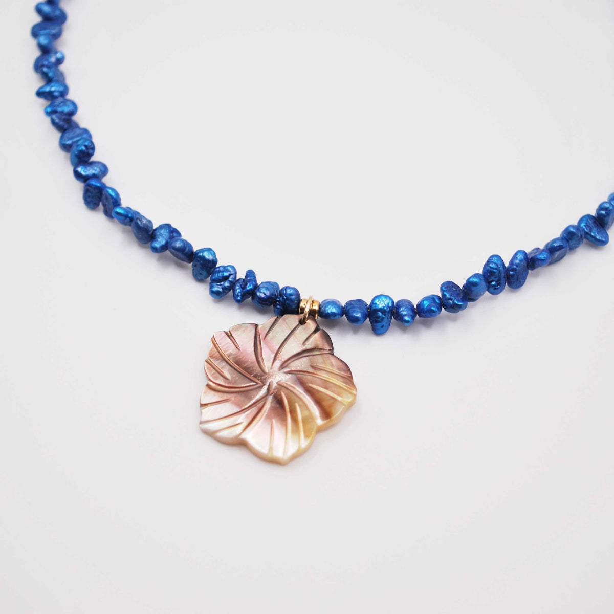 ‘twilight pearl’ blue keshi pearl necklace with carved shell pendant