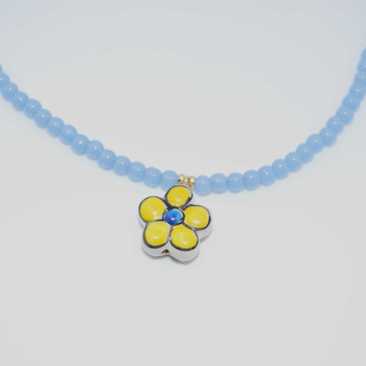 ‘periwinkle daisy’ blue beaded necklace with enamel flower charm