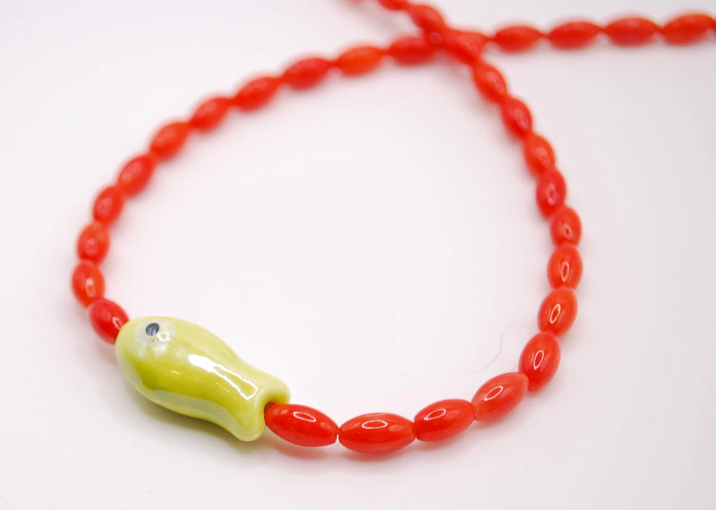 'blue tide minnow' necklace with lime green fish charm