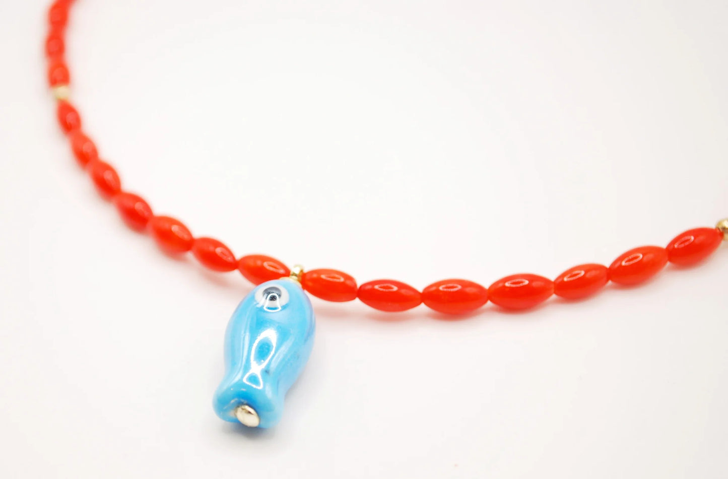 'orange tide' beaded necklace with blue fish charm